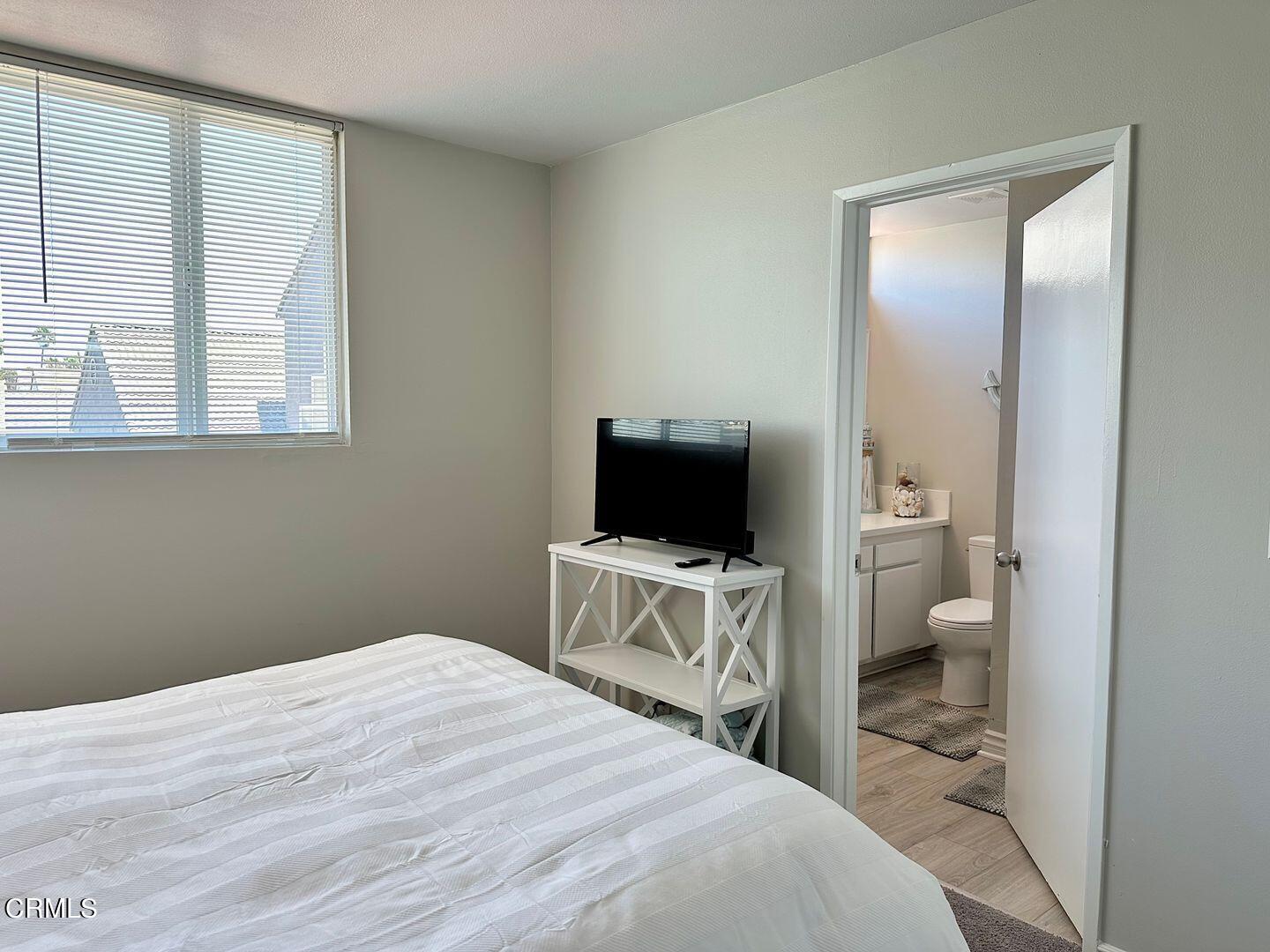 1364 Neptune Square Oxnard, CA 93035 - Photo 32 of 42 a bedroom with a bed and a flat screen tv