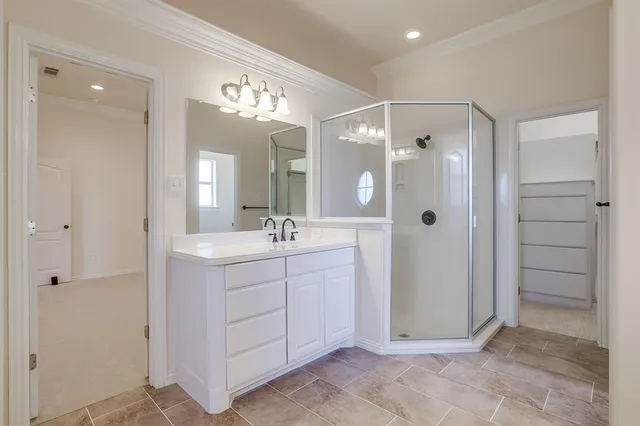 a bathroom with a double vanity sink mirror and shower