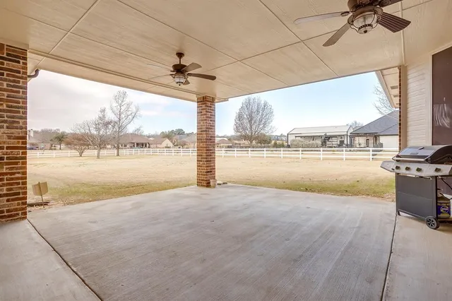 a view of a livingroom with wooden floor and a floor to ceiling window