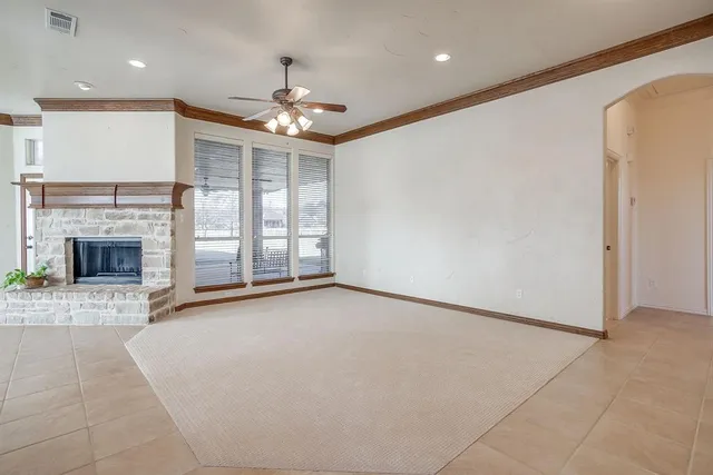 a view of an empty room with a fireplace