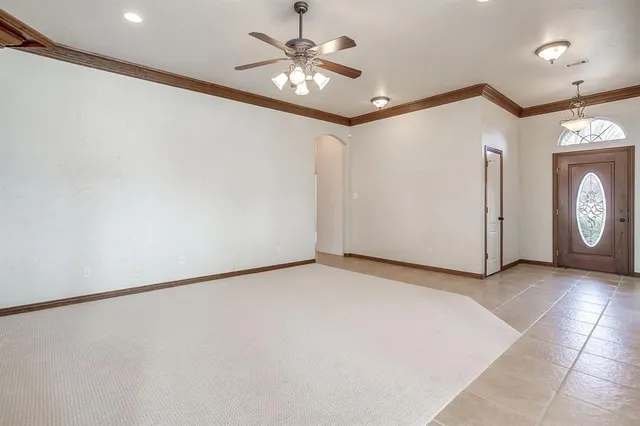 a view of a livingroom with a ceiling fan and wooden floor