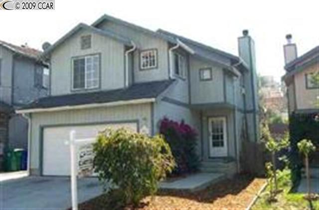 923 Third Street Rodeo, CA 94572 - Photo 1 of 1 a front view of a house with a yard