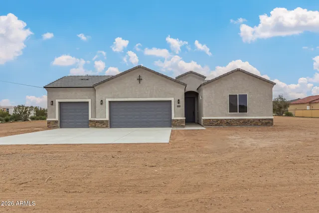 a view of a house with a yard and garage