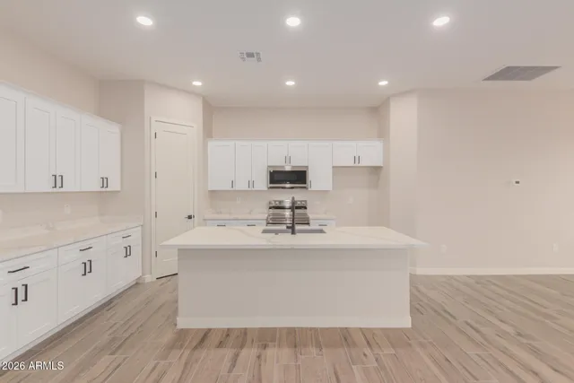 a kitchen with stainless steel appliances a sink stove and cabinets