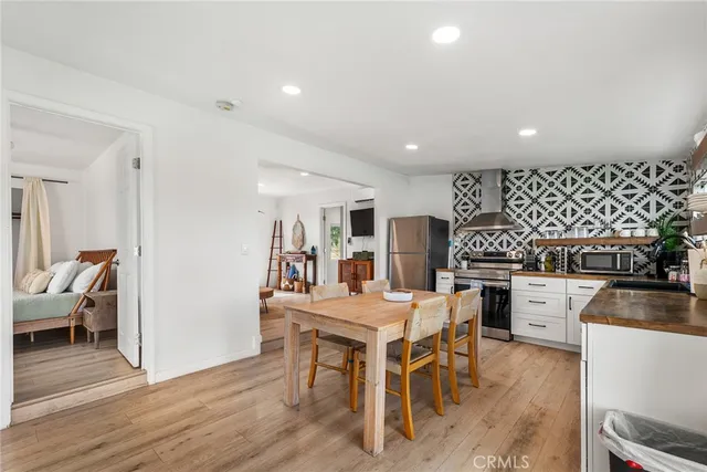 a living room with furniture and view of kitchen