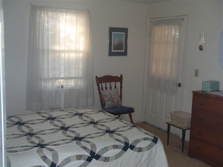 101 Depot Road, Unit 3/C Chatham, MA 02633 - Photo 5 of 13 a bedroom with a bed and a chair in it