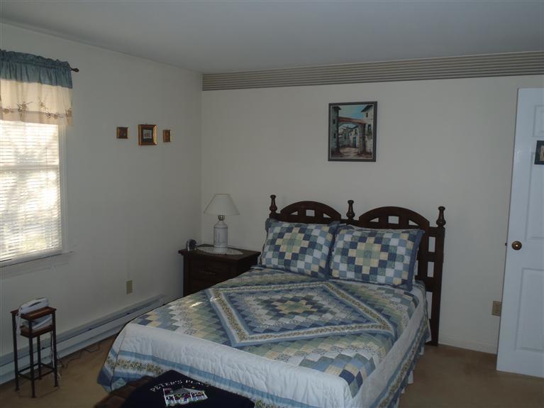 101 Depot Road, Unit 3/C Chatham, MA 02633 - Photo 10 of 13 a bedroom with a bed and wooden floor