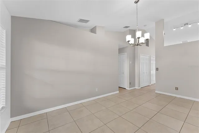 a view of a chandelier fan and entryway