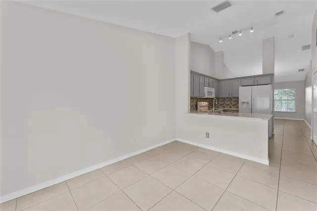 a view of kitchen with refrigerator and window
