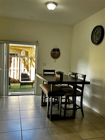a living room with a bed furniture and a wooden floor