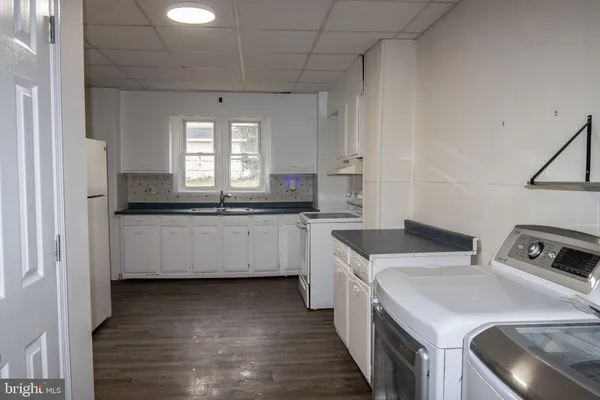 a kitchen that has a sink and a stove in it