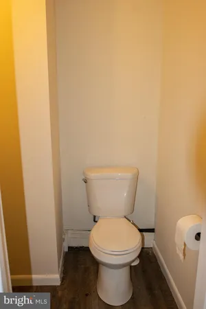 a white toilet sitting next to a sink