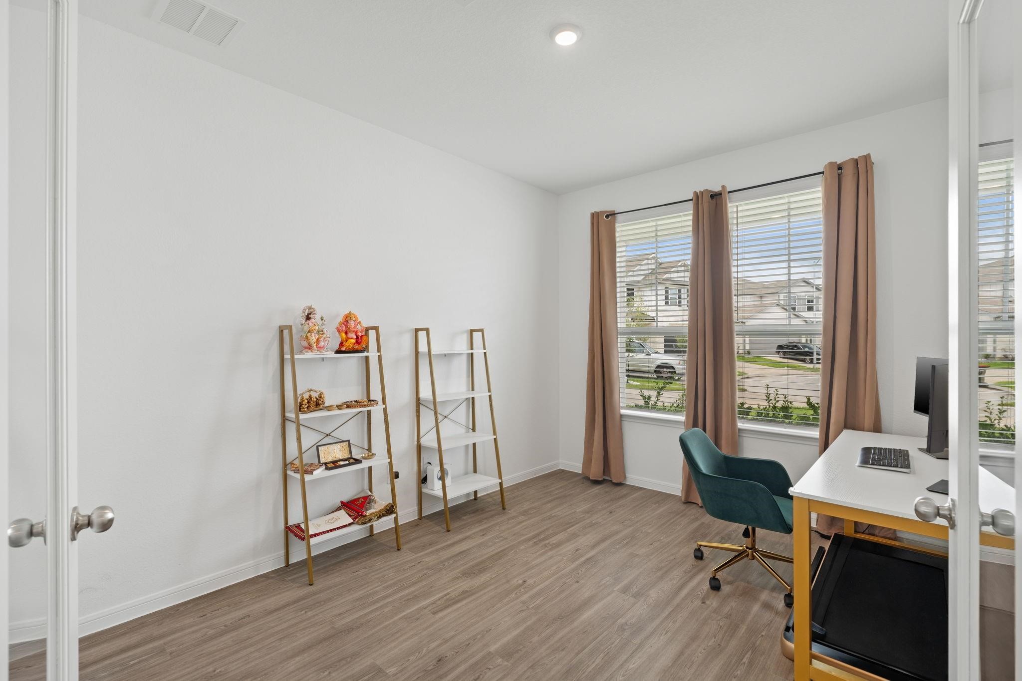23543 Powmill Street Spring, TX 77373 - Photo 11 of 32 a view of a workspace with furniture and a window