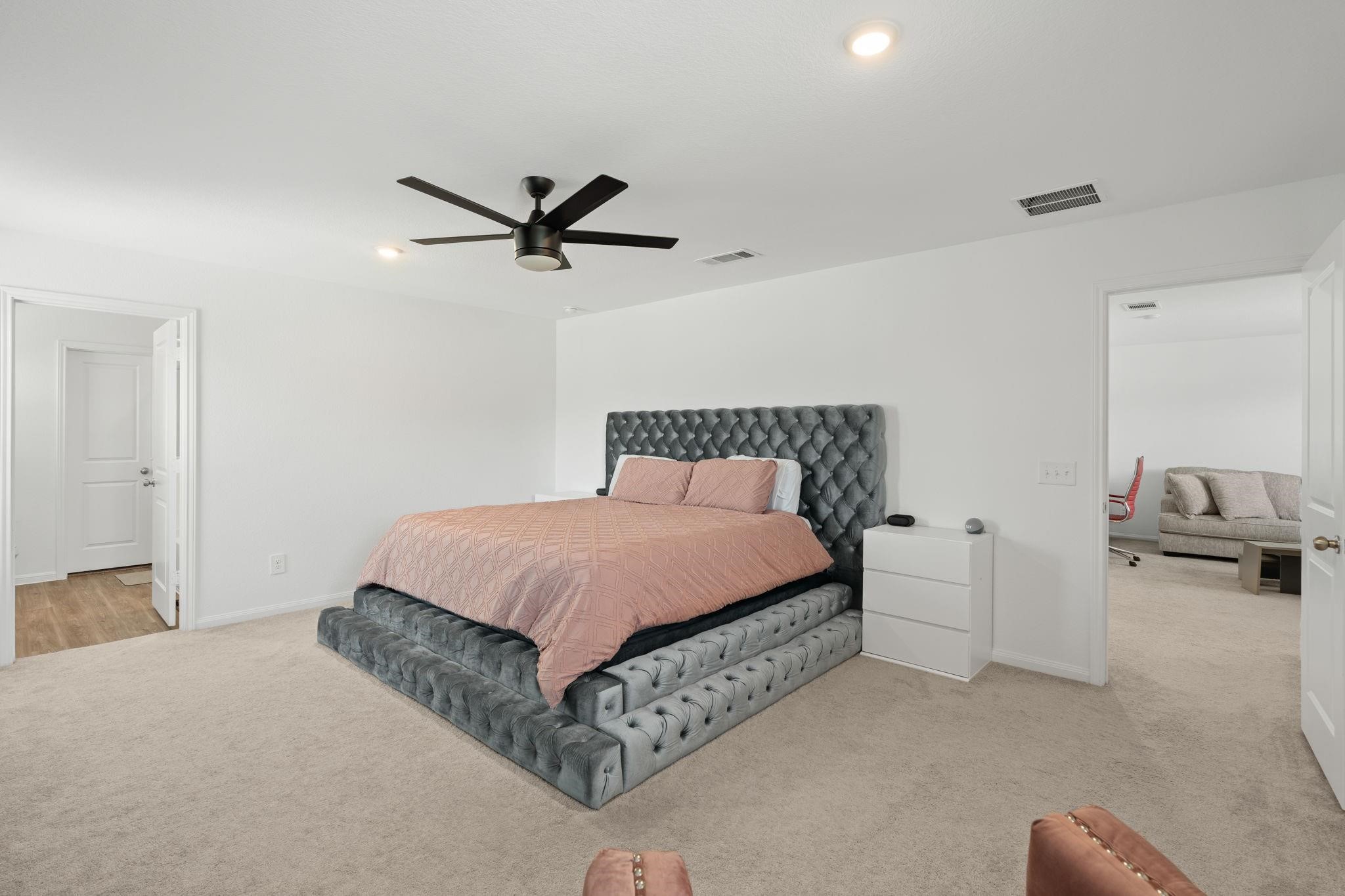 23543 Powmill Street Spring, TX 77373 - Photo 12 of 32 a bedroom with a bed and a ceiling fan