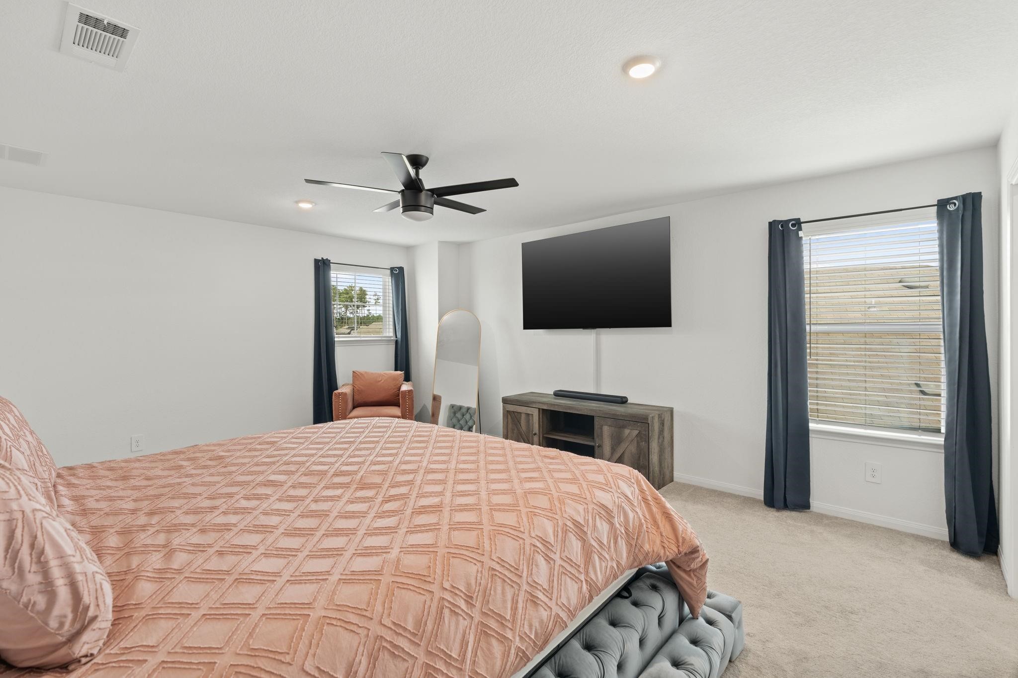 23543 Powmill Street Spring, TX 77373 - Photo 14 of 32 a bedroom with a bed and a flat screen tv