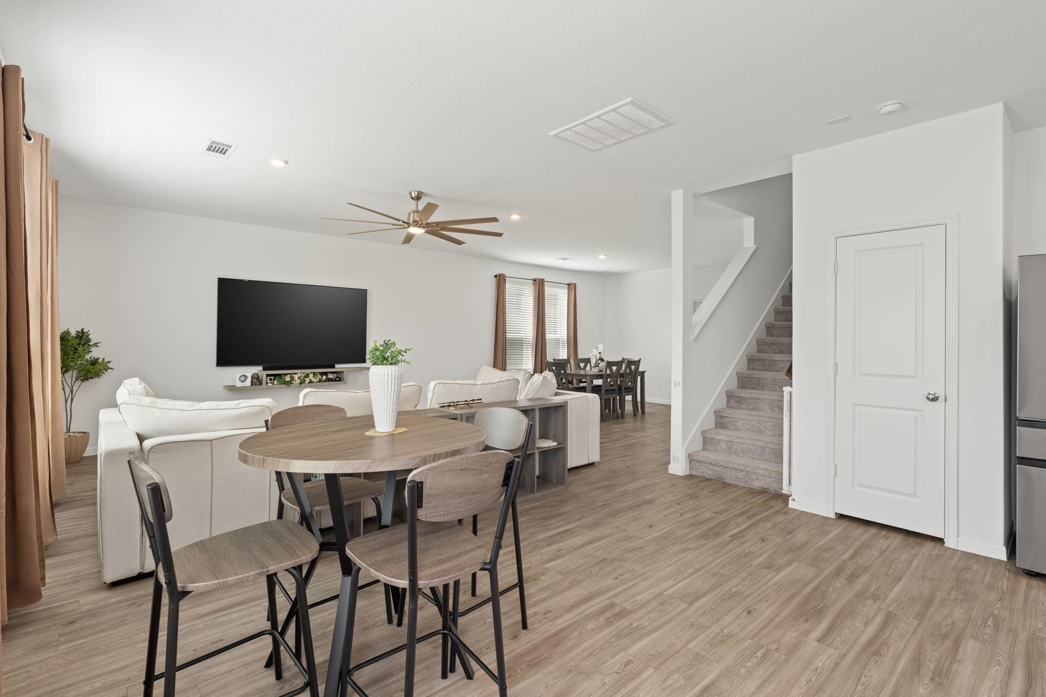 23543 Powmill Street Spring, TX 77373 - Photo 8 of 32 a view of a dining room with furniture wooden floor and a flat screen tv
