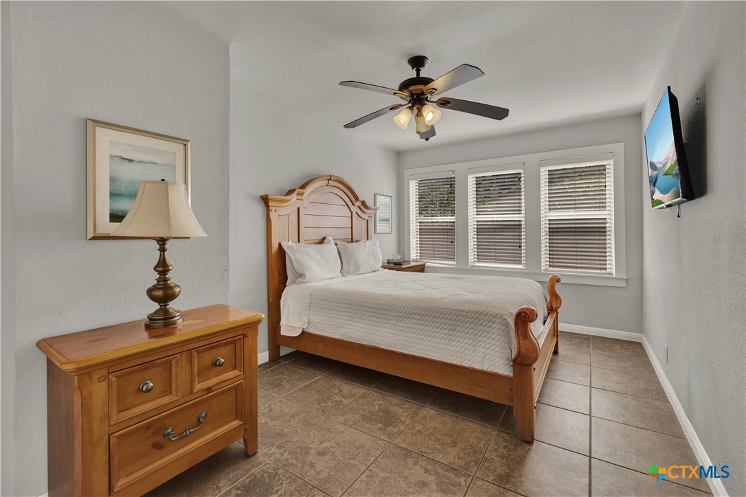 1015 Reiley Road Seguin, TX 78155 - Photo 15 of 45 a bedroom with a bed and a chandelier