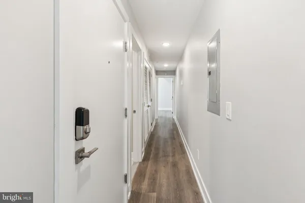 a view of a hallway with wooden floor