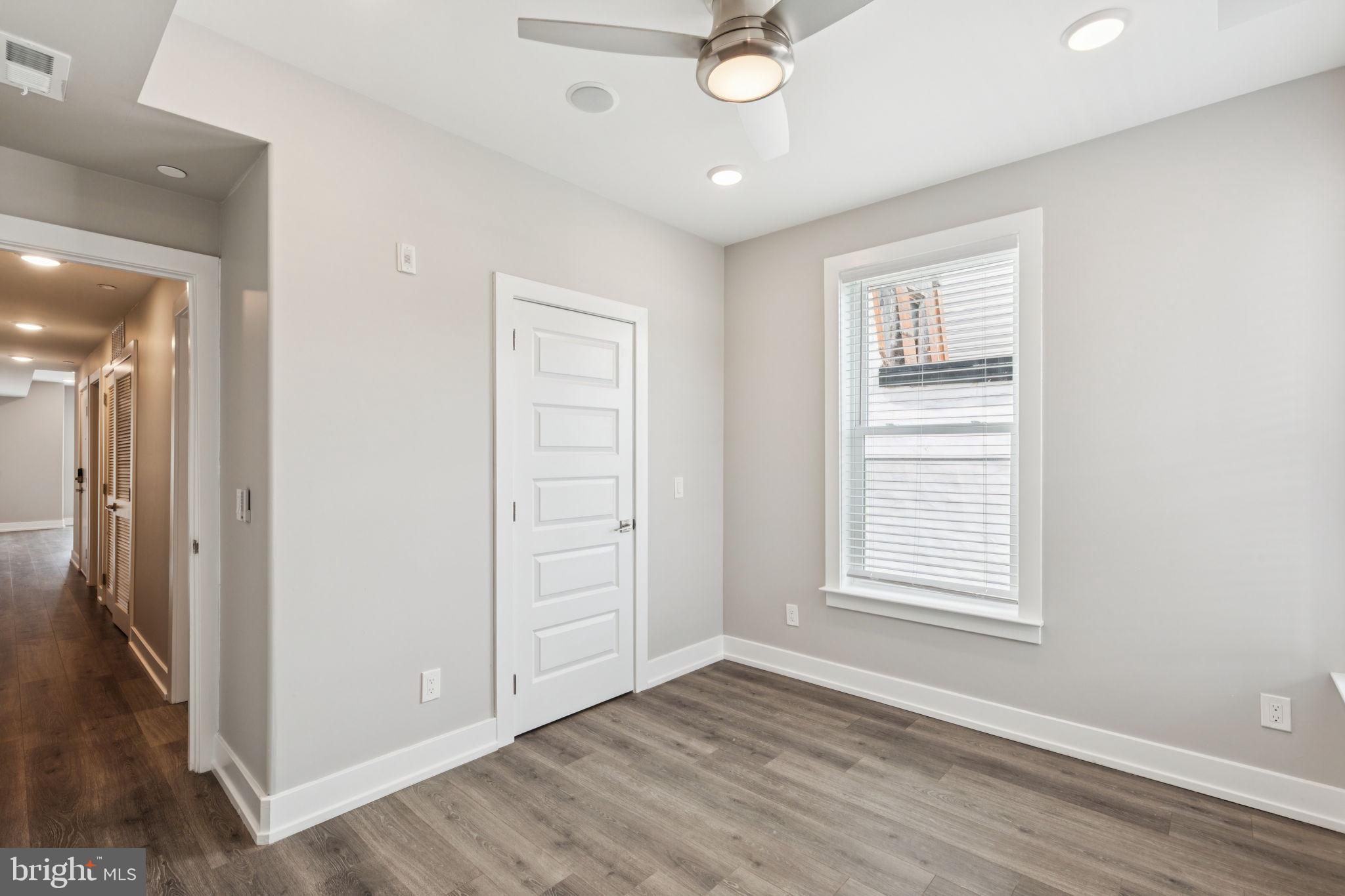 2531 North Front Street, Unit 2 Philadelphia, PA 19133 - Photo 21 of 25 an empty room with wooden floor cabinet and windows