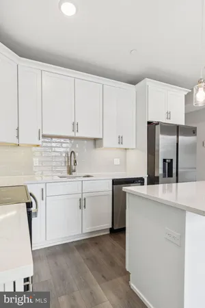 a kitchen with cabinets appliances a sink and a counter top space