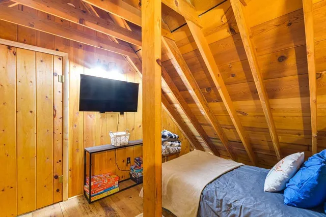 a bed room with a bed and a flat screen tv