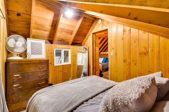 a bedroom with a bed and a mirror