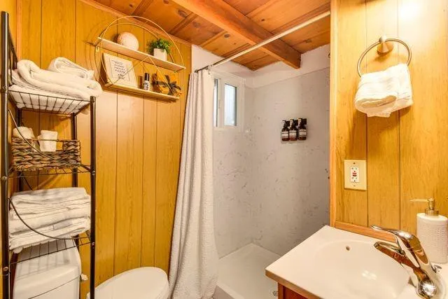 a bathroom with a sink toilet and shower