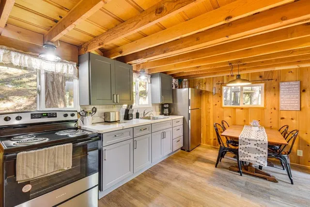 a kitchen with a sink cabinets and wooden floor