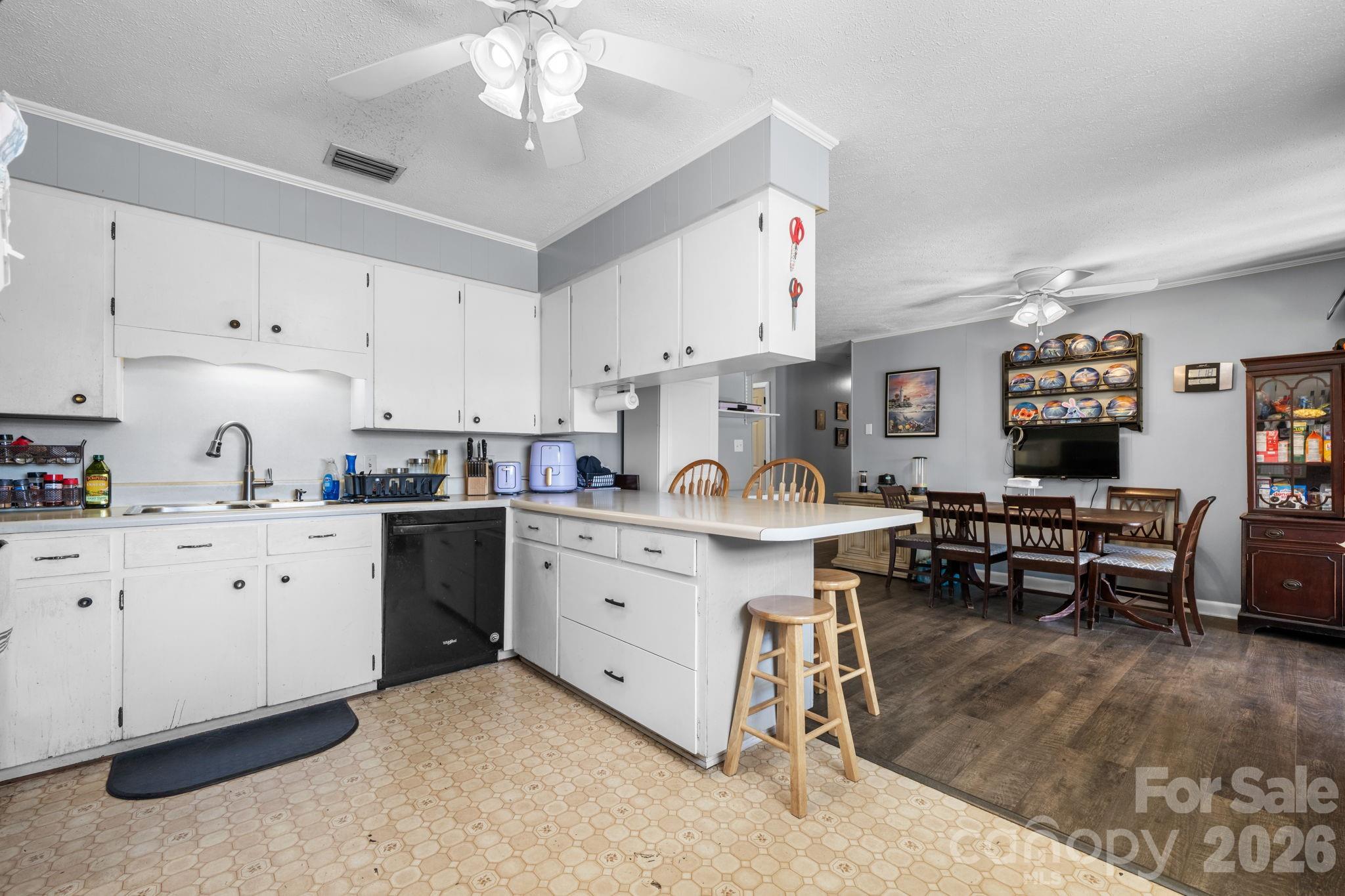 103 Hamp Street Morganton, NC 28655 - Photo 11 of 42 a kitchen with cabinets appliances and a dining table