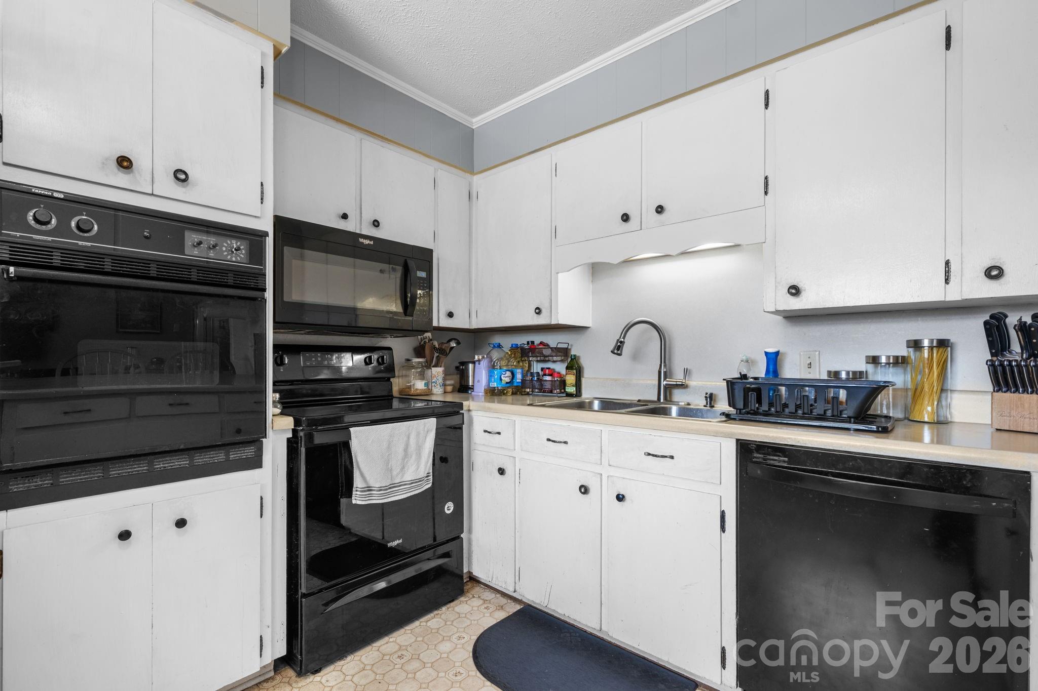 103 Hamp Street Morganton, NC 28655 - Photo 12 of 42 a kitchen with cabinets stainless steel appliances and a sink