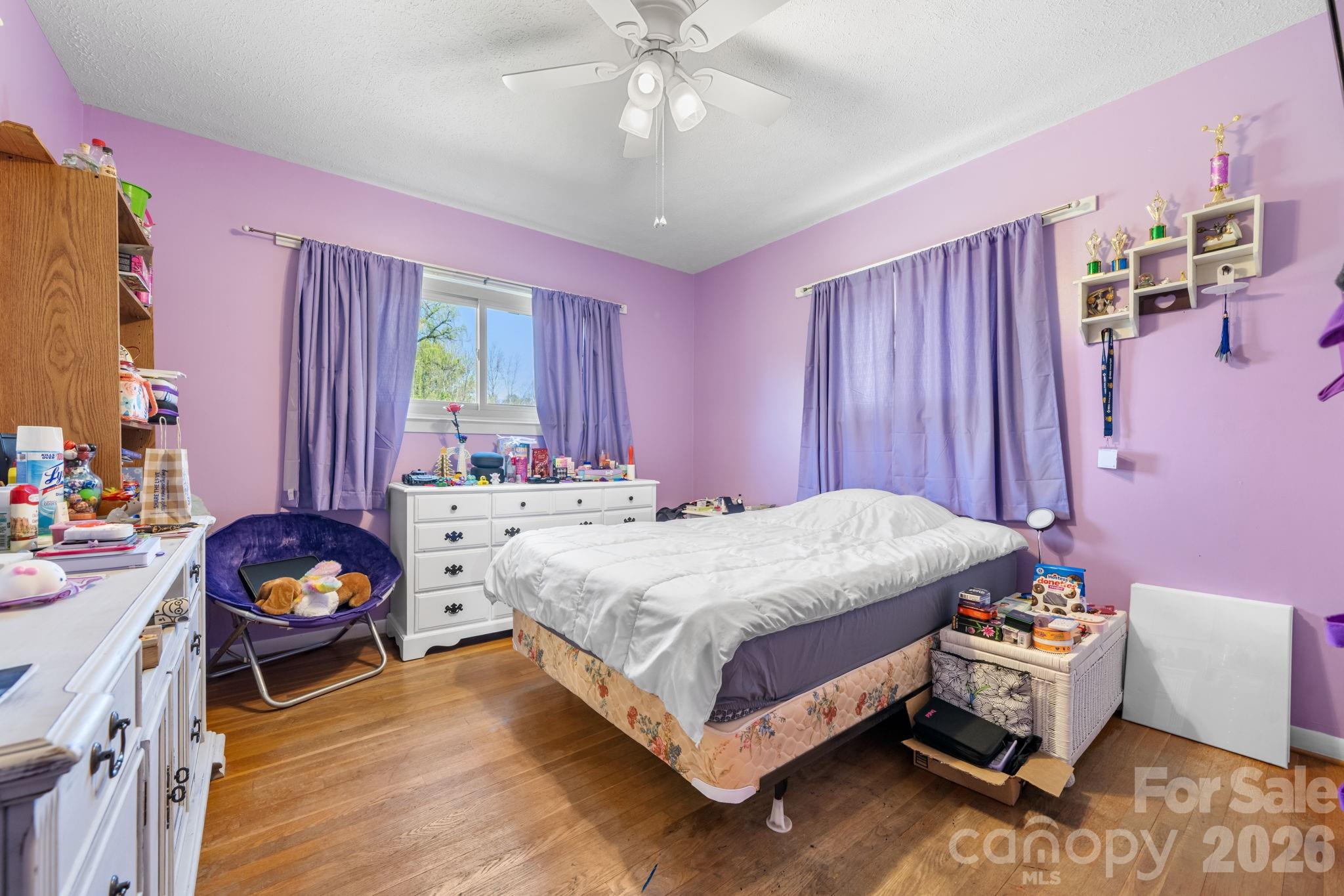 103 Hamp Street Morganton, NC 28655 - Photo 17 of 42 a bedroom with a bed and a chandelier