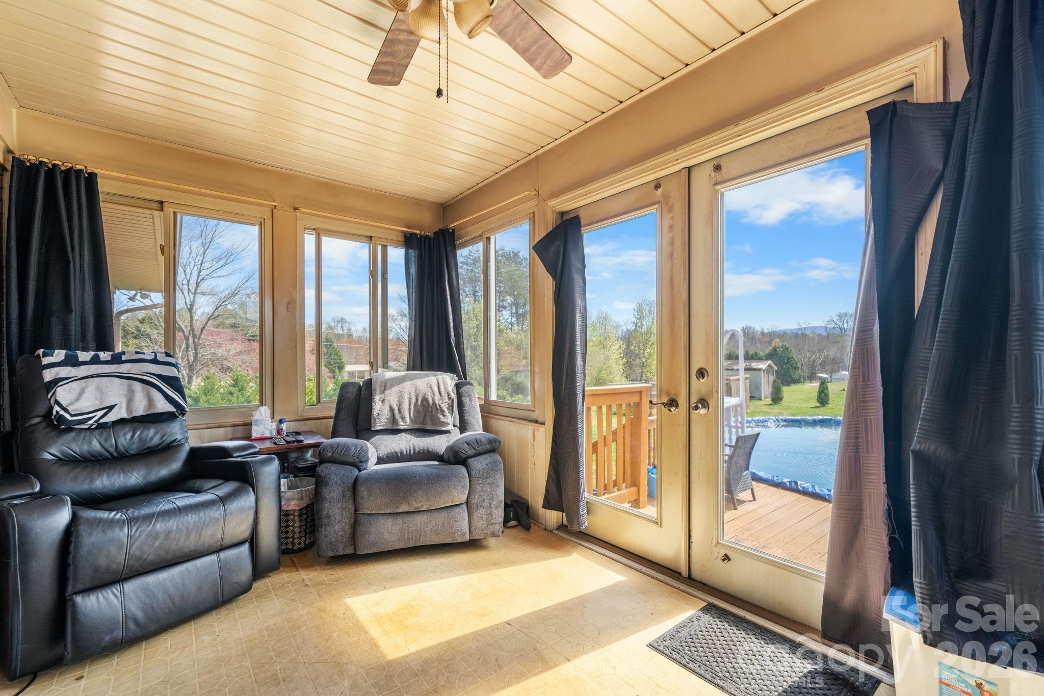 103 Hamp Street Morganton, NC 28655 - Photo 22 of 42 a living room with furniture and a floor to ceiling window