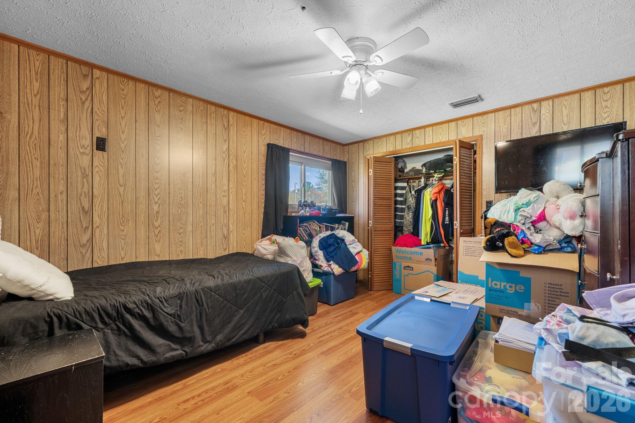 103 Hamp Street Morganton, NC 28655 - Photo 23 of 42 a bedroom with furniture and a chandelier