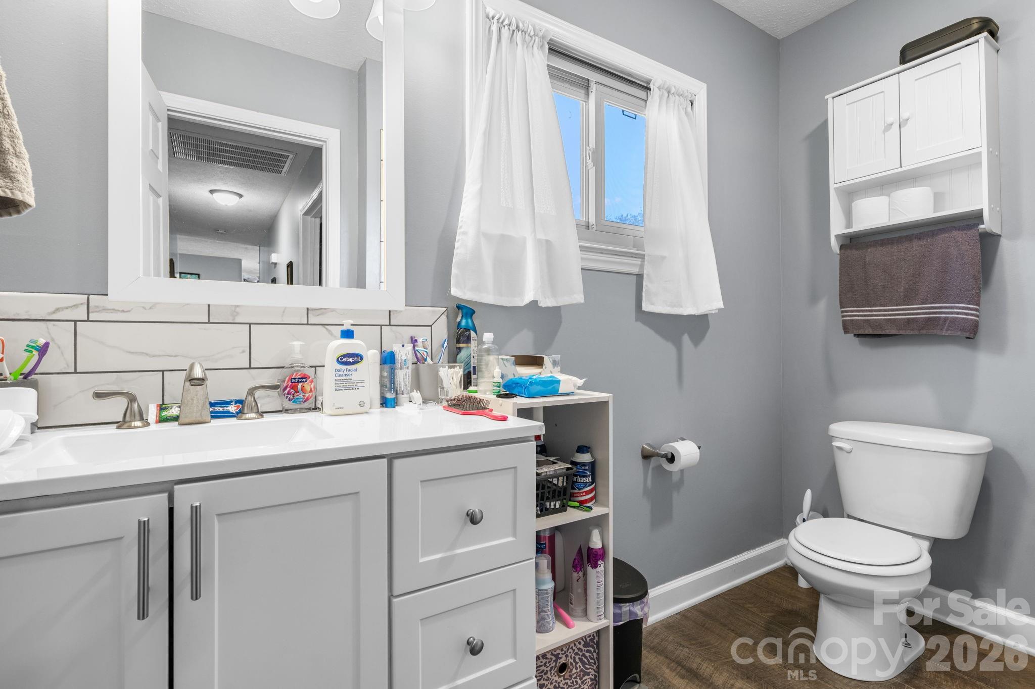 103 Hamp Street Morganton, NC 28655 - Photo 24 of 42 a bathroom with a sink toilet vanity and window
