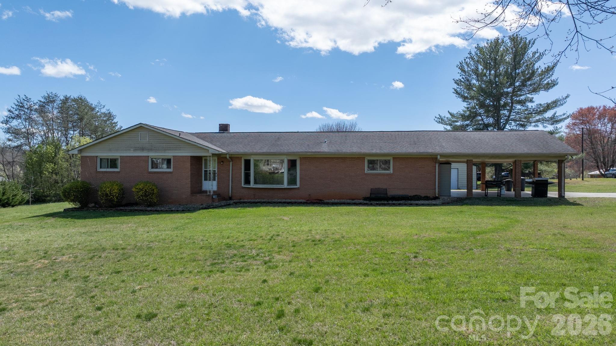 103 Hamp Street Morganton, NC 28655 - Photo 3 of 42 a view of a house with a big yard and a large tree