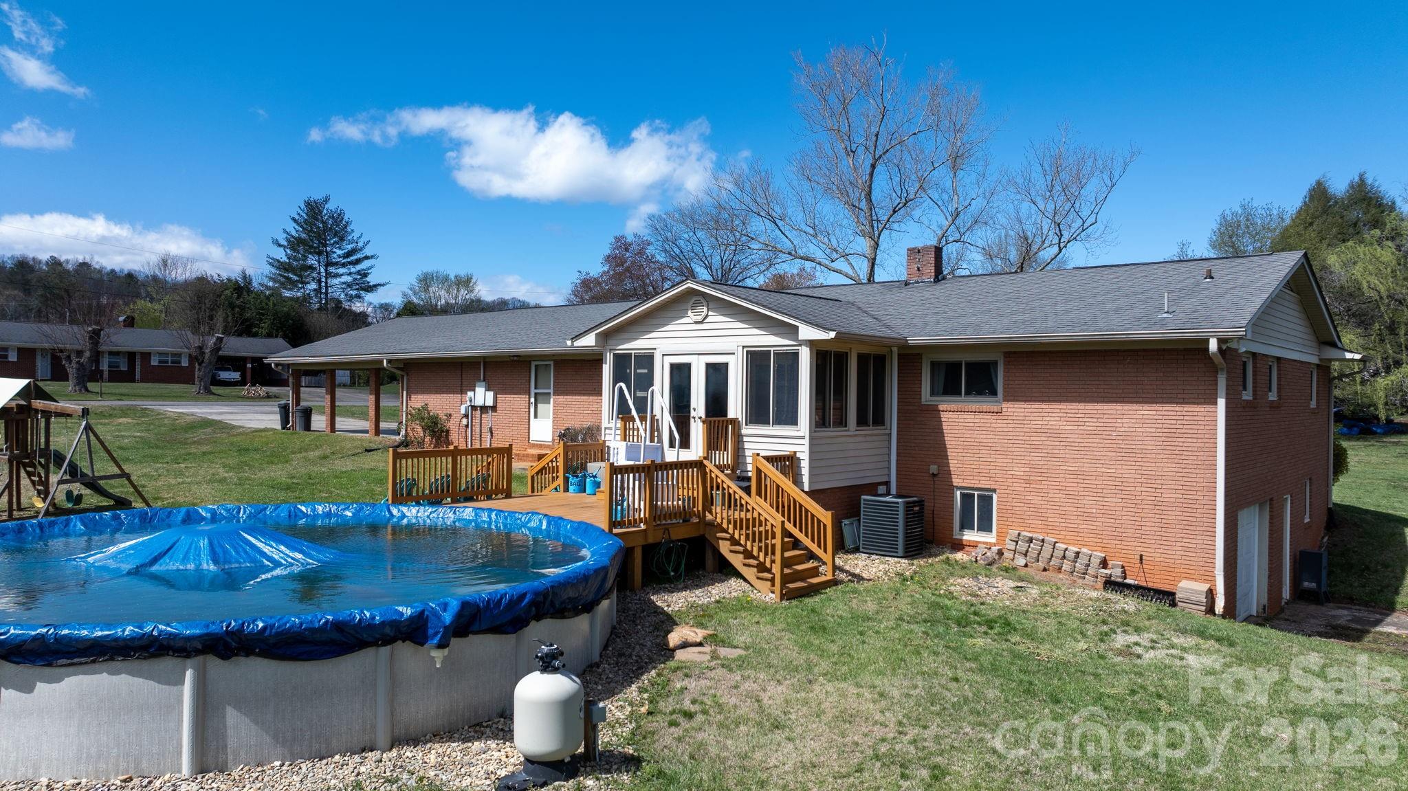 103 Hamp Street Morganton, NC 28655 - Photo 32 of 42 a view of a house with backyard tub and couches