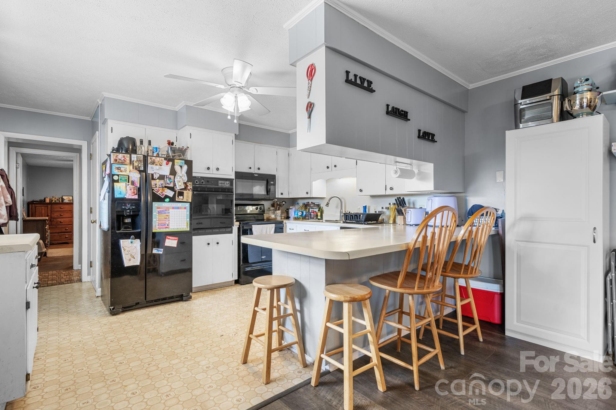 103 Hamp Street Morganton, NC 28655 - Photo 10 of 42 a kitchen with stainless steel appliances kitchen island granite countertop a table and chairs in it