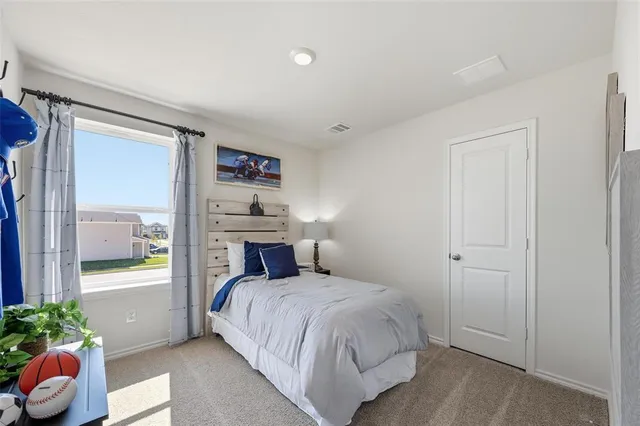 a bedroom with furniture and a window