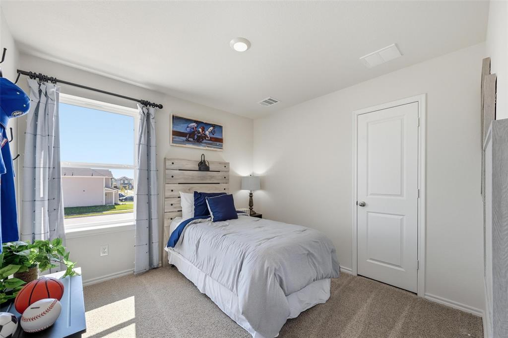 6016 Primrose Road Princeton, TX 75407 - Photo 11 of 23 a bedroom with a bed and a potted plant