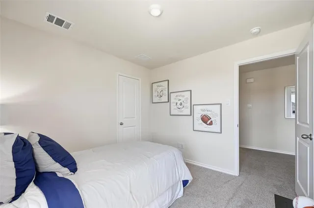 a bedroom with a bed and a potted plant