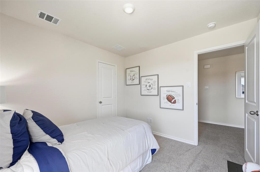 6016 Primrose Road Princeton, TX 75407 - Photo 12 of 23 a bedroom with a bed and wall painting