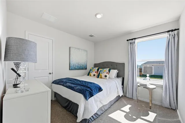 a bedroom with a bed and wall painting