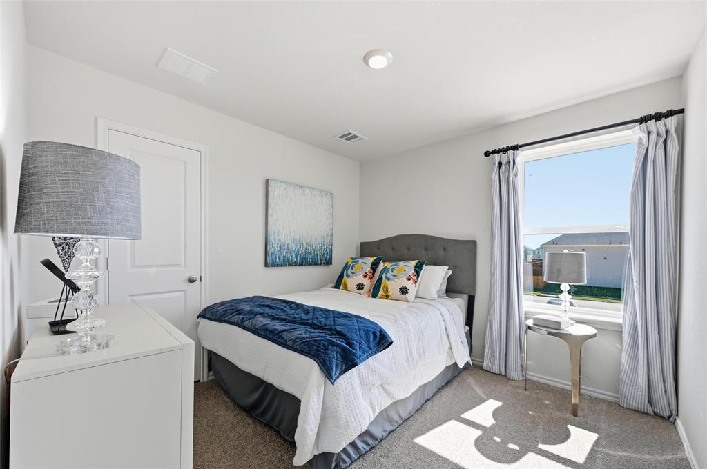 6016 Primrose Road Princeton, TX 75407 - Photo 13 of 23 a bedroom with a bed and a mirror