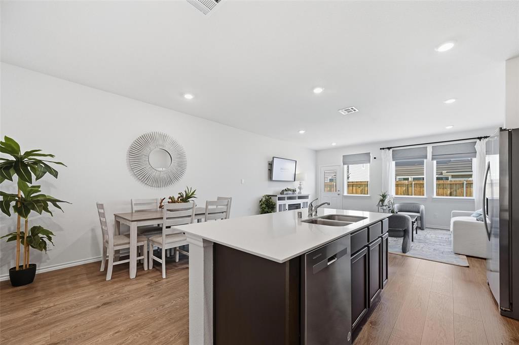 6016 Primrose Road Princeton, TX 75407 - Photo 20 of 23 a room with stainless steel appliances a dining table chairs and couches