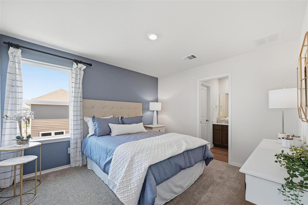 6016 Primrose Road Princeton, TX 75407 - Photo 5 of 23 a bedroom with a large bed and a potted plant