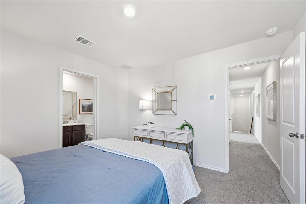 6016 Primrose Road Princeton, TX 75407 - Photo 6 of 23 a bedroom with a bed and a flat screen tv