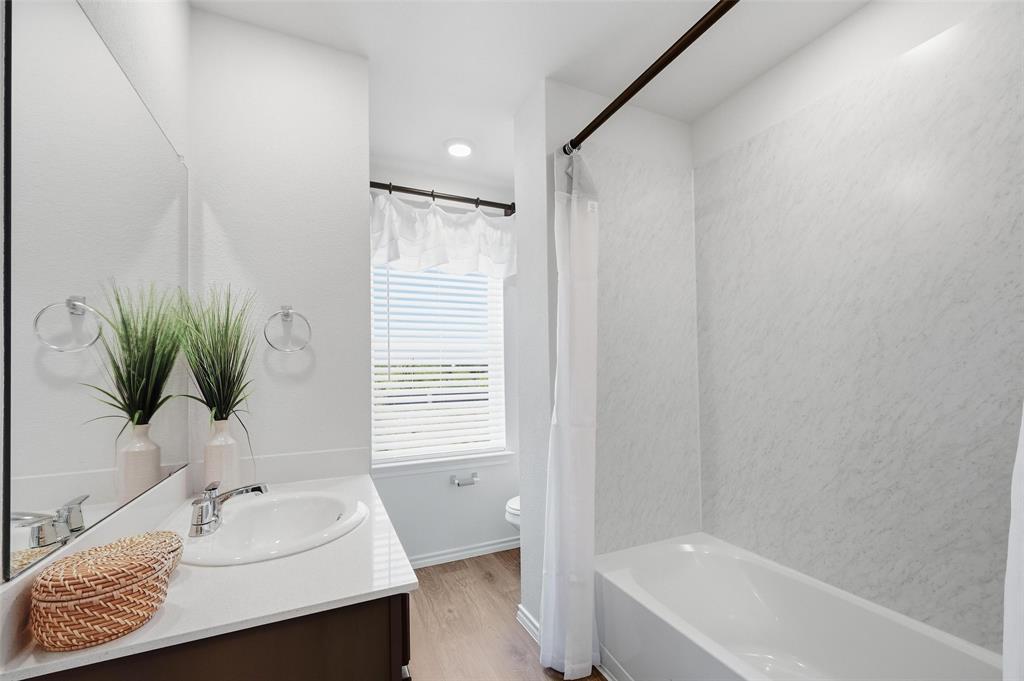 6016 Primrose Road Princeton, TX 75407 - Photo 9 of 23 a bathroom with a sink and a mirror