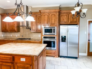 1306 Keenland Road Corpus Christi, TX 78418 - Photo 18 of 26 a kitchen with stainless steel appliances granite countertop a refrigerator a oven and a sink with granite countertops