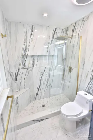 a bathroom with a toilet sink and shower