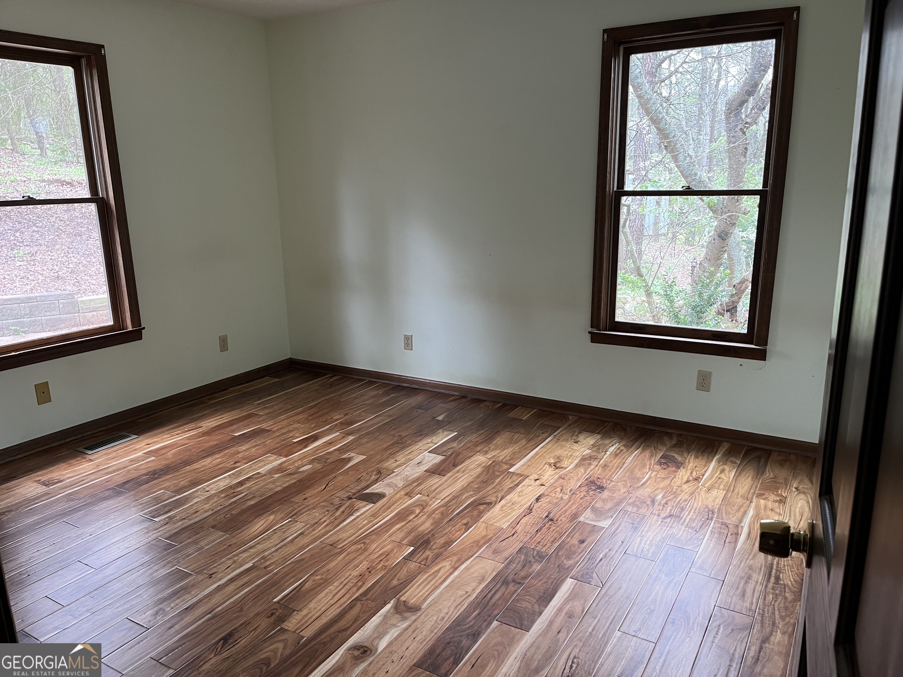 475 Davis Road Southwest Cave Spring, GA 30124 - Photo 17 of 27 a view of empty room with wooden floor and fan